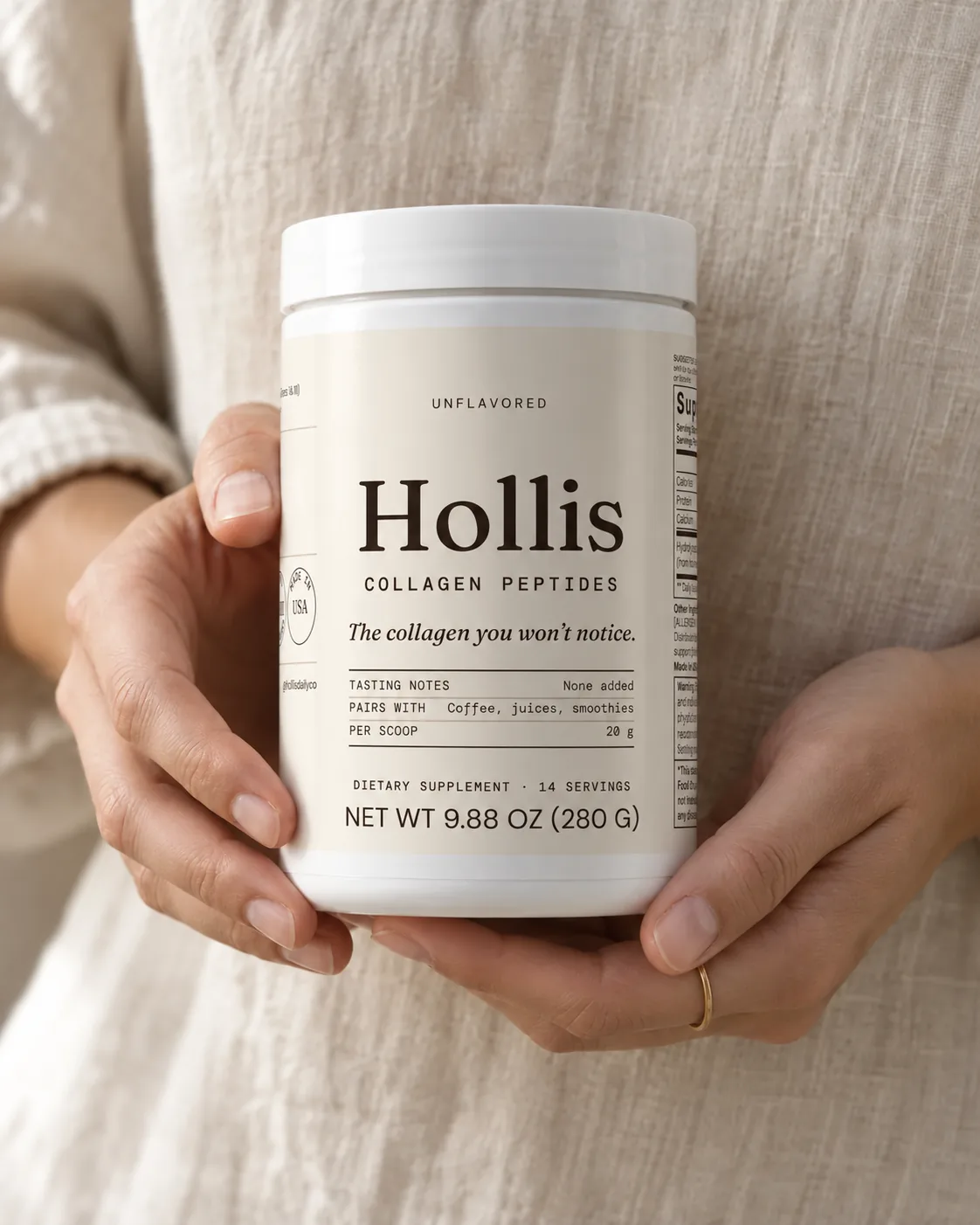 Hands holding a container of Hollis Collagen Peptides